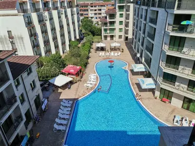 an overhead view of a swimming pool in a building at Family Apartments Amadeus lux in Sunny Beach