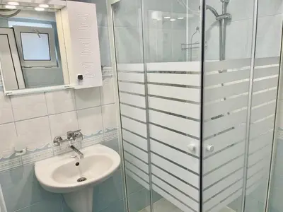 a bathroom with a sink and a glass shower at Апартамент Свети Влас in Sveti Vlas