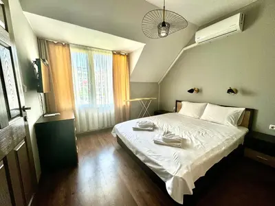 a bedroom with a large bed with two towels on it at Апартамент Свети Влас in Sveti Vlas