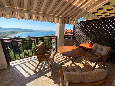 a patio with a table and chairs on a balcony at Sunrise - Apartment 41,Santa Marina, Sozopol in Sozopol