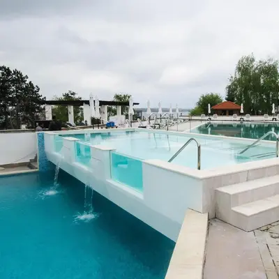 a swimming pool with blue water at Sunrise - Apartment 41,Santa Marina, Sozopol in Sozopol