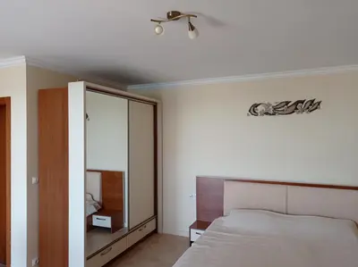 a bedroom with a bed and a mirror at Sunrise - Apartment 41,Santa Marina, Sozopol in Sozopol