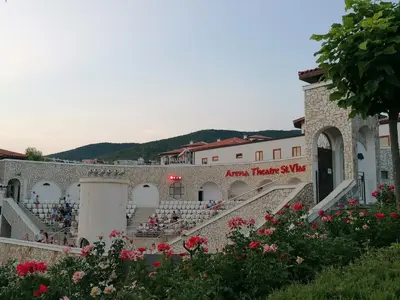 a group of people sitting on the stairs of a building at Apartment Casa del Mar (Dinevi Resort) in Sveti Vlas
