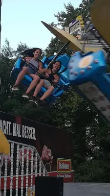 two people riding on a roller coaster at a theme park at Rich-2 SP apartments in Ravda