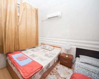 a small bedroom with a bed and a window at Summer Downtown - Compact Basic Flat - 1st floor in Burgas City