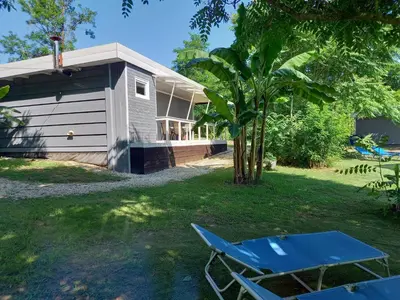 a blue chair and a tree in front of a house at SRB Sadovo-Resort-Bulgaria in Sadovo