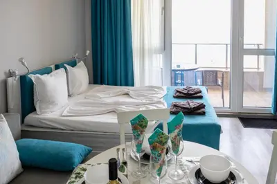 a hotel room with a bed and a table at A-33-Sea View Studio Apartment Sarafovo in Burgas City