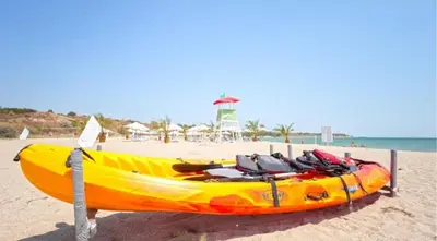a yellow kayak sitting on the beach near the ocean at A-33-Sea View Studio Apartment Sarafovo in Burgas City