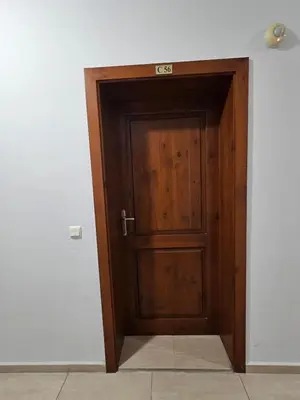a wooden door with a sign on top of it at Apartament in sun waves in Burgas City