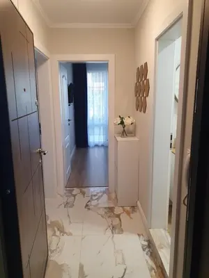 a hallway with a floor that is covered in marble at Sarafovo Sea Star in Burgas City