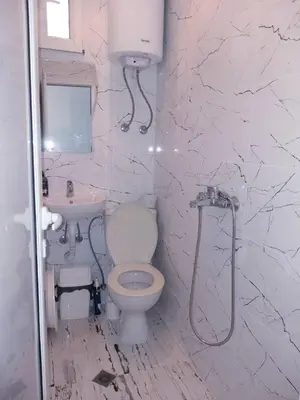 a white bathroom with a toilet and a sink at APARTMENT AMORE in Varna City