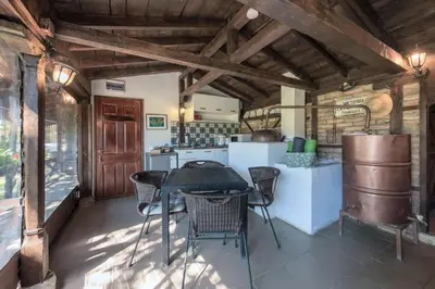 a kitchen with a table and chairs in a room at Villa Viara in Pchelnik