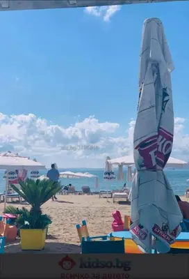 a beach with an umbrella on the sand at A-19 Sea View Studio-Apartmen Sarafovo in Burgas City