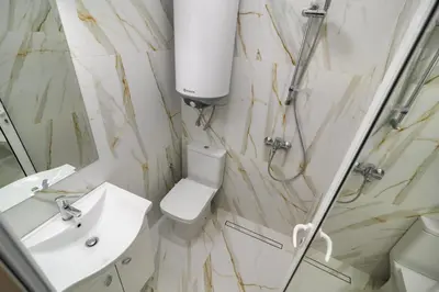 a bathroom with a toilet and a sink and a shower at Апартамент BOHO CHIC Free parking in Varna City
