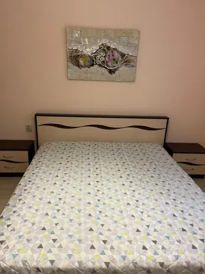 a bed in a bedroom with a bed frame at Apartment Lazur Karlovo 8 street free parking in Burgas City