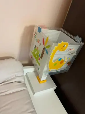 a plastic box with a dinosaur on it next to a bed at Apartment Lazur Karlovo 8 street free parking in Burgas City