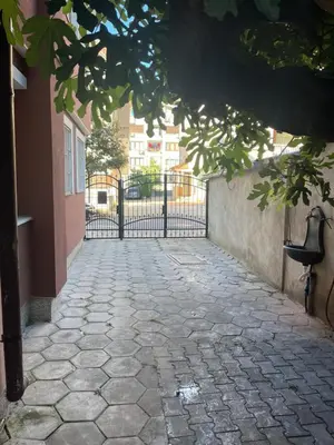 a stone walkway with a gate in front of a building at Apartment Lazur Karlovo 8 street free parking in Burgas City