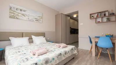 a bedroom with a bed with pink towels on it at Студио Булаир 1 с безплатен паркинг in Burgas City