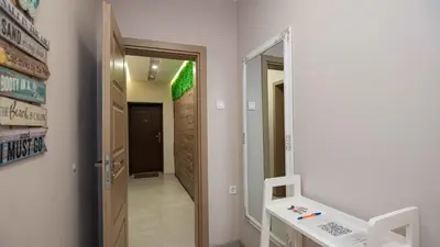 a hallway with a mirror and a door to a room at Студио Булаир 1 с безплатен паркинг in Burgas City