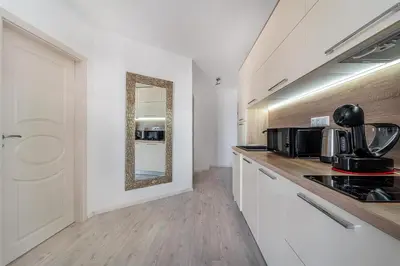 a kitchen with a counter top and a mirror at Premium complex Millennium 2 - Family apartment & Spa in Sveti Vlas