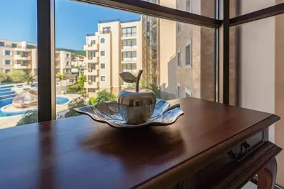 a bowl on a table in front of a window at Premium complex Millennium 2 - Family apartment & Spa in Sveti Vlas