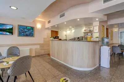 a bar in a restaurant with chairs and a counter at Paraiso Beach - All Inclusive in Obzor