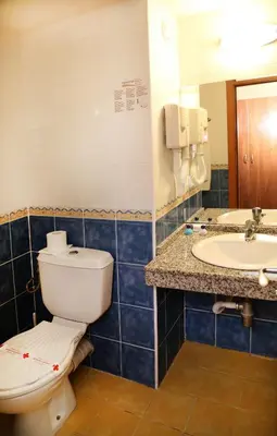 a bathroom with a toilet and a sink at Paraiso Beach - All Inclusive in Obzor