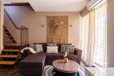 a living room with a couch and a table at Quiet Maisonette \u30e1 Free Parking in Varna City