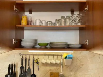 a kitchen cabinet with plates and utensils in it at Midia Grand Resort, Terrassen Paradies Apartment in Aheloy