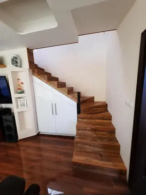 a staircase in a living room with wooden floors at The Penthouse in Varna City