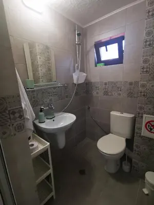 a bathroom with a toilet and a sink at DAMARIS in Sozopol