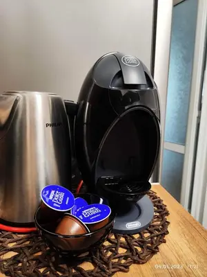 a coffee maker on a table next to a coffee pot at DeTY's Apartment in Burgas City