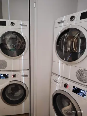 two washing machines and a washer and dryer in a room at DeTY's Apartment in Burgas City