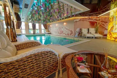 a swimming pool with wicker wicker chairs and a swimming pool at Monte Carlo in Sunny Beach