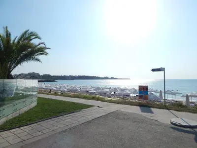 a view of the beach with a street light and the ocean at Dunav Apt.4 in Ravda