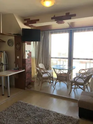 a living room with a table and chairs at Dunav Apt.4 in Ravda