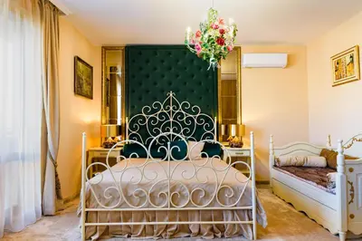 a bedroom with a bed and a chandelier at CASA ARTA in Burgas City