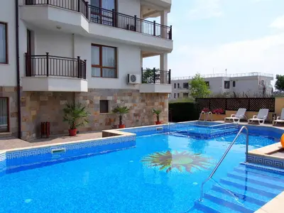 a large swimming pool in front of a building at Бяла Виста Бийч Апартментс B - Byala Vista Beach Apartments B in Byala