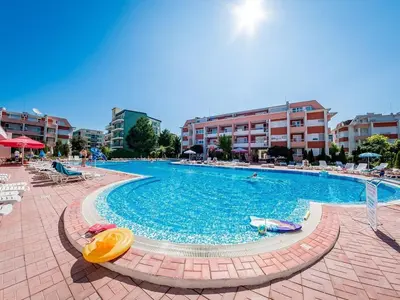 a large swimming pool with chairs and umbrellas in a resort at studio, sunny fort, sunny beach in Sunny Beach