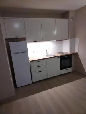 a kitchen with white cabinets and a sink and a refrigerator at studio, sunny fort, sunny beach in Sunny Beach