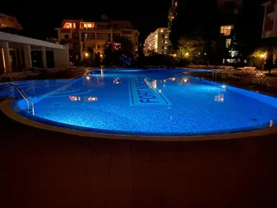 a large pool of blue water at night at studio, sunny fort, sunny beach in Sunny Beach