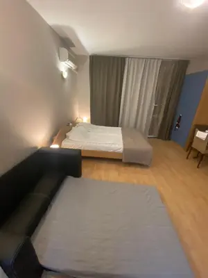 a hotel room with two beds and a couch at studio, sunny fort, sunny beach in Sunny Beach