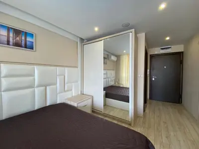 a bedroom with a bed and a large mirror at PARADISO 'В' 107 Private Cozy Studio NESSEBAR in Nesebar
