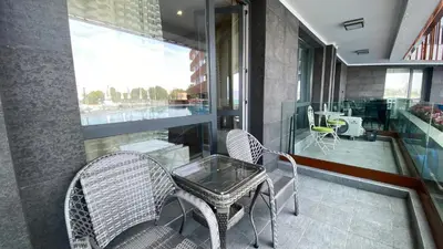 a balcony with two chairs and a table and a window at PARADISO 'В' 107 Private Cozy Studio NESSEBAR in Nesebar