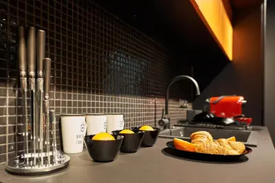 a kitchen counter with plates of oranges and croissants at Premium Luxury SeaSide Apartment in Burgas City