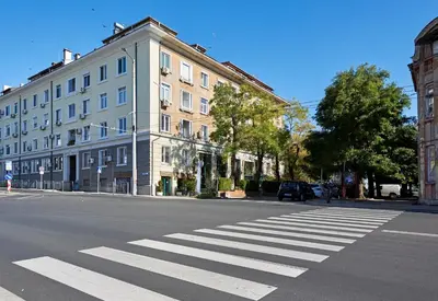 an empty street with a crosswalk in front of a building at Premium Luxury SeaSide Apartment in Burgas City