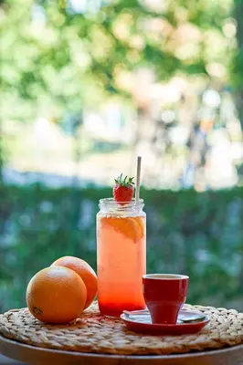 a drink in a jar and two oranges on a table at Premium Luxury SeaSide Apartment in Burgas City