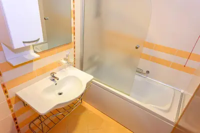 a bathroom with a sink and a shower at СПА Апартаменти за ГОСТИ Затворен комплекс ЕМЕРАЛД in Ravda