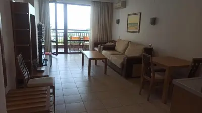 a living room with a couch and a table at СПА Апартаменти за ГОСТИ Затворен комплекс ЕМЕРАЛД in Ravda