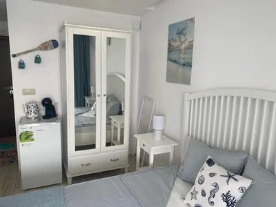 a bedroom with a bed and a large mirror at PARADISO 'B' 108 Private Cozy Room NESSEBAR in Nesebar